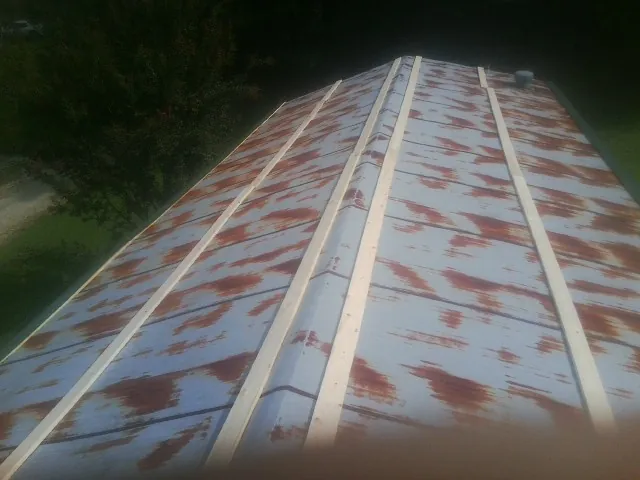Rusted metal roof panels with new wood purlins before replacement — Storm Damage Roof Repair in Jerome by Roofing Brothers